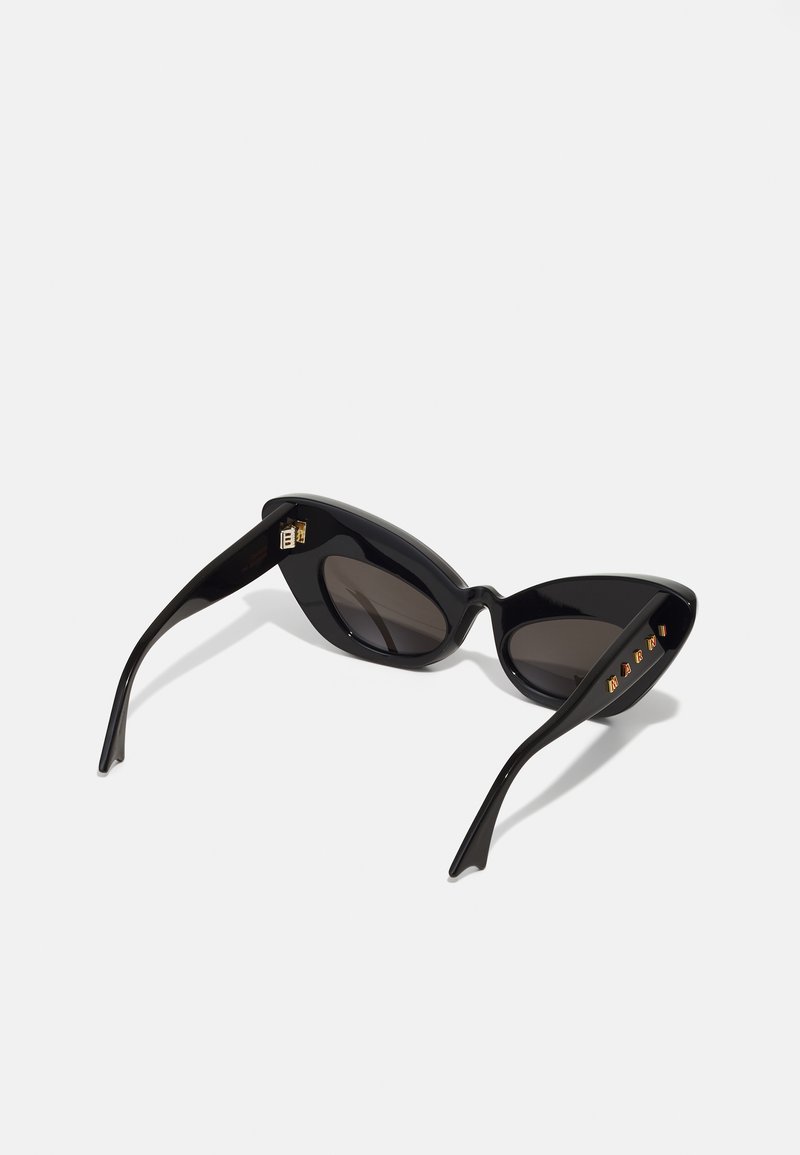 Cat-eye sunglasses in black plastic with dark lenses. Features gold accents on temples and a sleek, angular design.
