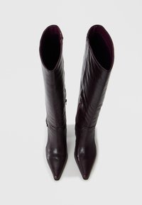 Knee-high boots made of smooth, dark purple leather with a pointed toe, featuring a slight texture and subtle zip detail on the side.