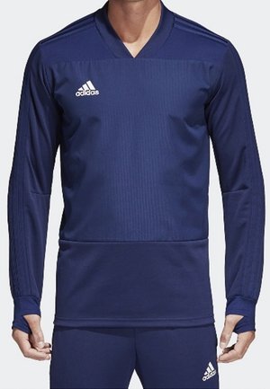Marineblauw sportief langemouwen jersey met V-hals, geribbelde textuur en wit logo op de borst, met duimopeningen op de manchetten.