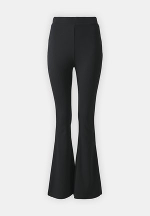 Black flared trousers made from stretchy fabric. Features a high waistband and a smooth, fitted design that flares from the knee downward.