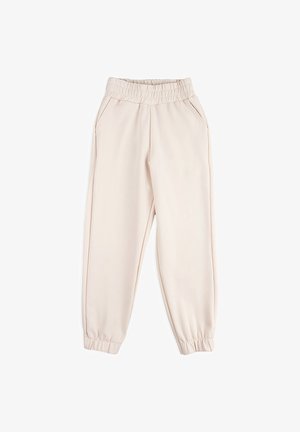 Beżowe spodnie dresowe wykonane z miękkiego materiału, z elastycznym pasem, bocznymi kieszeniami oraz elastycznymi mankietami przy kostkach. Gładka struktura.