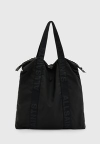 Black tote bag made of nylon with a soft texture, featuring long, flat straps embossed with "ALLSAINTS" and a zip closure at the top.