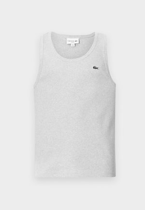 Débardeur en coton gris avec un col rond. Présente un petit logo Lacoste noir brodé sur la poitrine gauche. Design classique, sans manches.