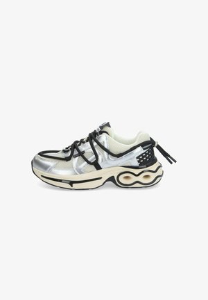 Silver and black athletic shoe with mesh upper, textured accents, and a distinctive curved sole design. Features flat laces and branding.