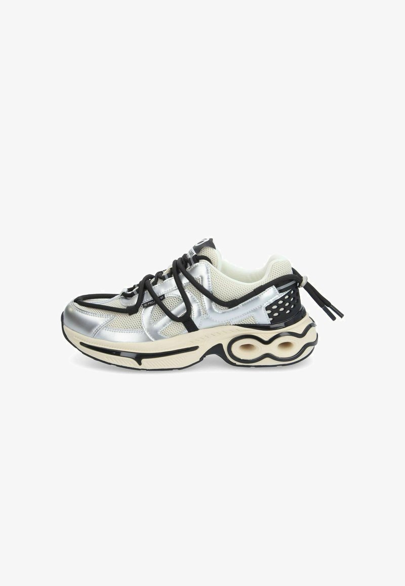 Silver and black athletic shoe with mesh upper, textured accents, and a distinctive curved sole design. Features flat laces and branding.
