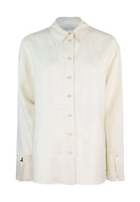 Camicia in lino crema con colletto a punta, maniche lunghe e chiusura con bottoni. Presenta dettagli dorati sui polsini e una vestibilità rilassata.