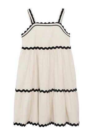 Vestido de lino color crema con ribete negro en forma de ondas, escote cuadrado y tirantes ajustables. Silueta evasé en línea A con un dobladillo en volantes.