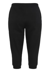 Pantaloni sportivi neri con un design affusolato, vita elastica, polsini a coste e tasche laterali. Realizzati in tessuto morbido e traspirante.