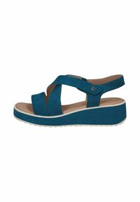 Tyrkysové semišové klínové sandály mají křížové popruhy, zadní pásek a kontrastní bílou podrážku. Design klade důraz na pohodlí a stabilitu.