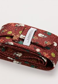 Cravatta rossa a fantasia con pupazzi di neve, omini di pan di zenzero e motivi natalizi. Realizzata in tessuto con una superficie liscia. Etichetta del marchio visibile.