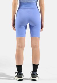 Hoge taille blauwe geribde fietsbroek, met een gladde textuur en een aangesloten ontwerp, dat tot halverwege de bovenbenen reikt.