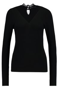 Maglione nero a maniche lunghe con scollatura a V e dettagli in pizzo al colletto. Texture liscia, design aderente e polsini e orlo a coste.