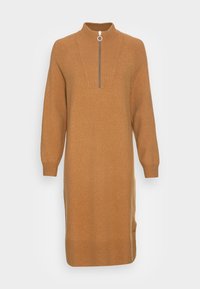 Brun sweatshirtklänning med hög krage och halv dragkedja, med långa ärmar och avslappnad passform. Tillverkad av mjukt, texturerat material.