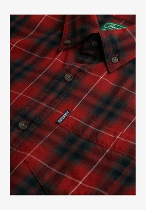 Red and black checked flannel shirt, featuring browns buttons, a white grid pattern, and a blue Superdry label on the front.