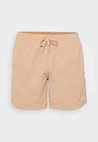 Beige fürdőnadrág rugalmas derékkal, elöl húzózsinórral, oldalzsebekkel és egy kis logó folttal. Sima, könnyű anyag.