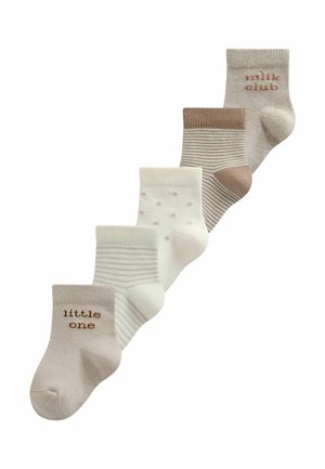 Five pairs of beige and white baby socks arranged in a diagonal row, featuring stripes, polka dots, and text reading "little one" and "milk club."