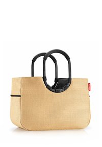 Tan woven tote bag with double black handles. Features a rounded design and a single black accent stripe along the side.