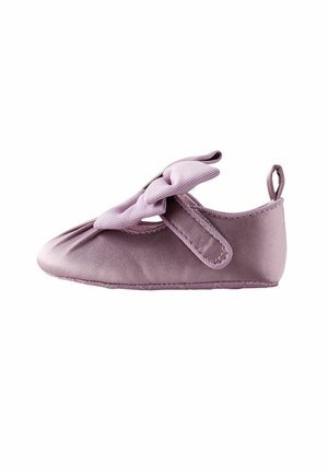 Soft pink baby shoe with a fabric bow on top and a hook-and-loop strap, shown from the side on a white background.