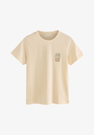 Camiseta beige de manga corta con cuello redondo, con un pequeño gráfico de un rollo de sushi en la parte izquierda del pecho.