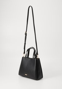 Black leather handbag with dual handles and a long adjustable strap. Features a triangular shape and subtle gold hardware accents.