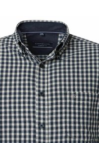 Checkered shirt in navy and cream, featuring a button-down collar, pocket detail, and smooth cotton fabric. Comfort fit design.