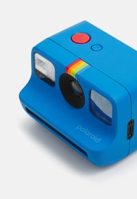 Blue plastic Polaroid camera featuring a red button, rainbow stripe, and a visible lens. Includes two viewfinder windows and USB-C port.