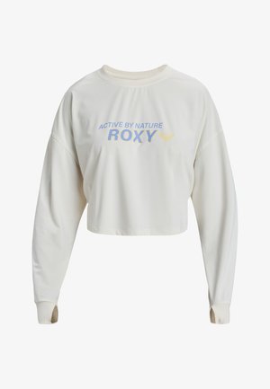 Sweatshirt court à manches longues couleur crème, avec un col rond, affichant "ACTIVE BY NATURE" et "ROXY" imprimés en bleu et jaune.