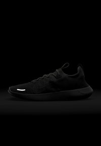 Black athletic shoe with a knitted upper, textured design, and a flexible sole. Features minimal white accent on the upper.