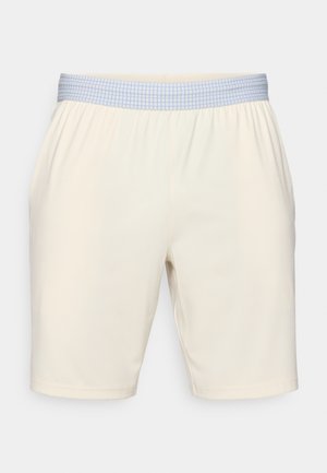 Shorts crème avec une taille élastique arborant un motif à carreaux bleu clair. Tissu lisse, coupe arrivant au genou, ourlet uni.