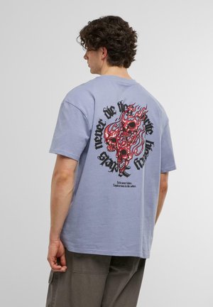 Light blue cotton t-shirt featuring a large red and black graphic of skulls and flames on the back, with stylized text above and below.