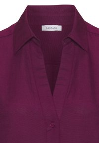 Plum button-up shirt with a collar, featuring a deep V-neck, smooth texture, and a single button closure at the chest. Lascana label visible.