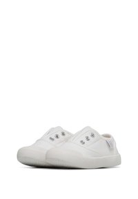 White canvas slip-on shoes with a textured rubber sole, featuring three metallic eyelets and a padded collar for comfort.