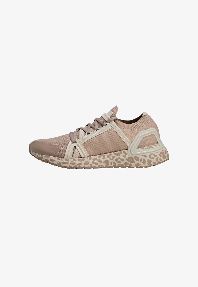 Sneakers featuring a textured, light pink upper with a beige leopard print sole, accented by beige straps and a distinctive heel design.