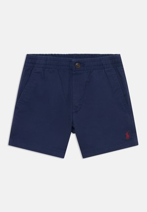 Námořnické modré šortky vyrobené z lehké tkaniny, s elastickým pasem, bočními kapsami a malým červeným logem na dolním levém rohu.