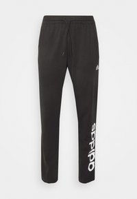 Melni sporta bikses, izgatavotas no kokvilnas maisījuma, ar elastīgu jostasvietu un auklu, kā arī baltu "adidas" logo, kas izsprinta uz kreisā kājas.