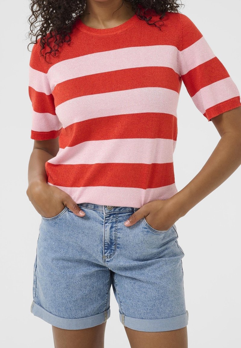 Red and pink striped short-sleeve sweater with a round neck, paired with light blue denim shorts, featuring rolled hems and side pockets.