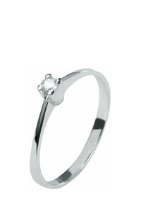 Silver solitaire ring with a single round-cut diamond held by four prongs on a polished, slender band.