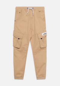 Béžové cargo kalhoty s elastickým pasem, bílou šňůrkou na stažení, bočními klopovými kapsami a značkovou etiketou Vingino na pravé kapse.