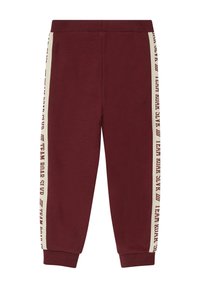 Burgunderfarbene Sweatpants aus weichem Material, mit cremefarbenen Seitestreifen und dem Text "TEAM ROAR", elastischem Bund und eng anliegenden Bündchen.