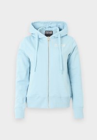 Svetlomodrá mikina na zips so sťahovacími šnúrkami, rebrovanými manžetami a lemom, s malým logom „Versace Jeans Couture“ na hrudi a na vnútornej štítku.