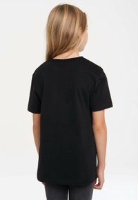 Black cotton t-shirt with short sleeves and a classic crew neck, featuring a simple design and plain texture, viewed from the back.