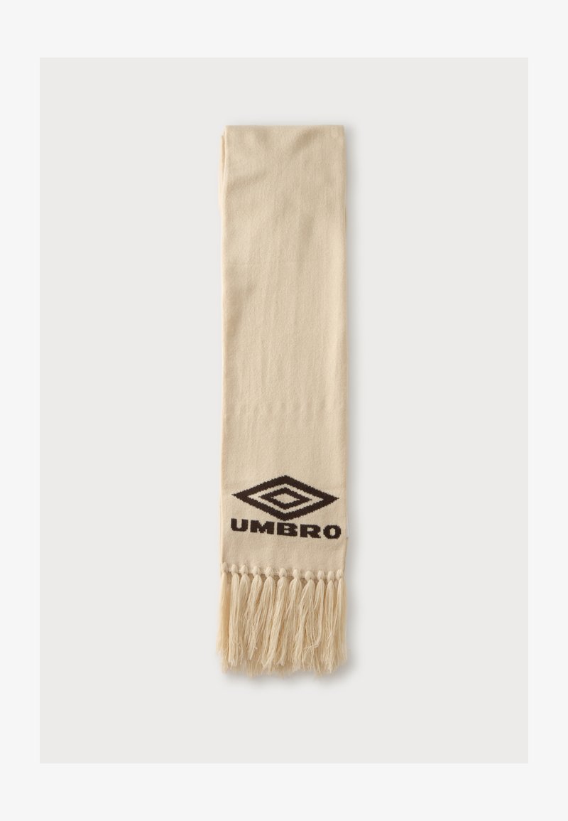 Бежов шал с пискюли от едната страна и черно лого Umbro в центъра над пискюлите.