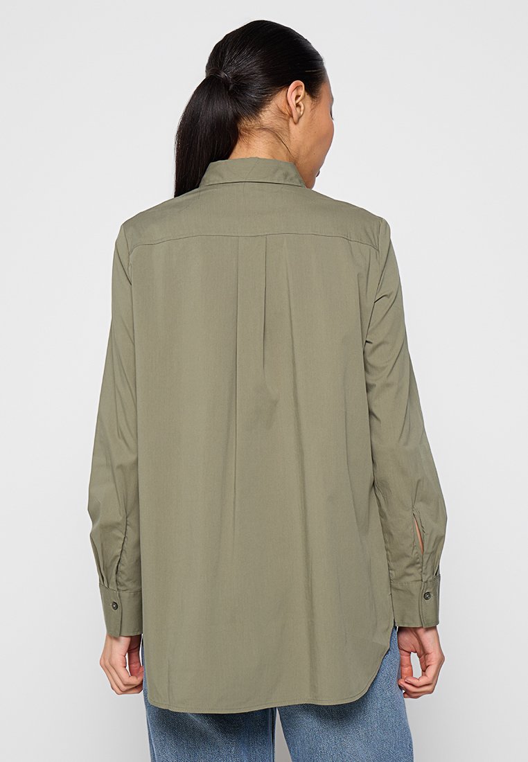Olivengrünes Langarmhemd mit Kragen, Rückenschlitzdetail, Knopfmanschetten und lockerer Passform, aus glattem Stoff gefertigt.