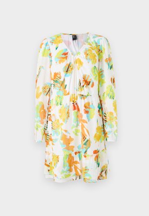 Vestido floral con base blanca, que presenta grandes patrones de hojas en naranja, verde y azul. Manga larga, escote en V y detalle de dobladillo con volantes.