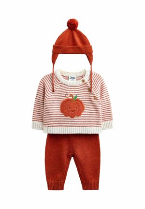 Toddler outfit with red knit hat with pom-pom, striped sweater featuring a smiling pumpkin, and matching red knit pants.