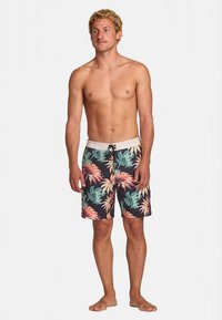 Floral swim shorts with a dark background; features large pink and green leaves. Elastic waistband with drawstring for adjustable fit.