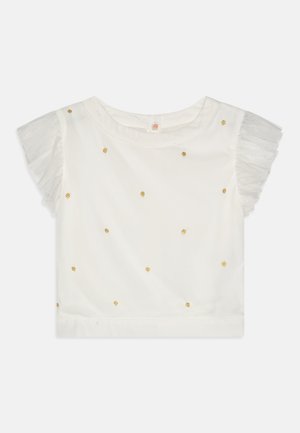 Biely krátky rukáv top s pozlátkovými bodkami a priesvitnými volánovými rukávmi. Navrhnutý s okrúhlym výstrihom a rovnými okrajmi.