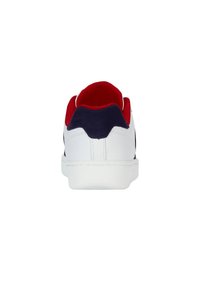 White sneaker with red and navy accents, featuring a textured material, curved heel, and a smooth sole. Clean design without logos.