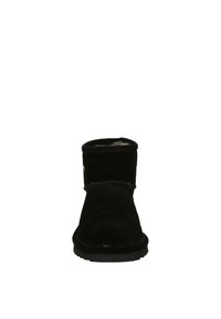 Black suede ankle boot with a rounded toe, soft interior lining, and a flat rubber sole; features visible stitching and a side logo detail.