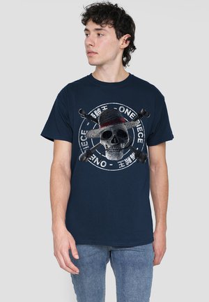 Navy cotton t-shirt featuring a large gray skull graphic, crossed bones, and text in white, on a circular design with a straw hat detail.